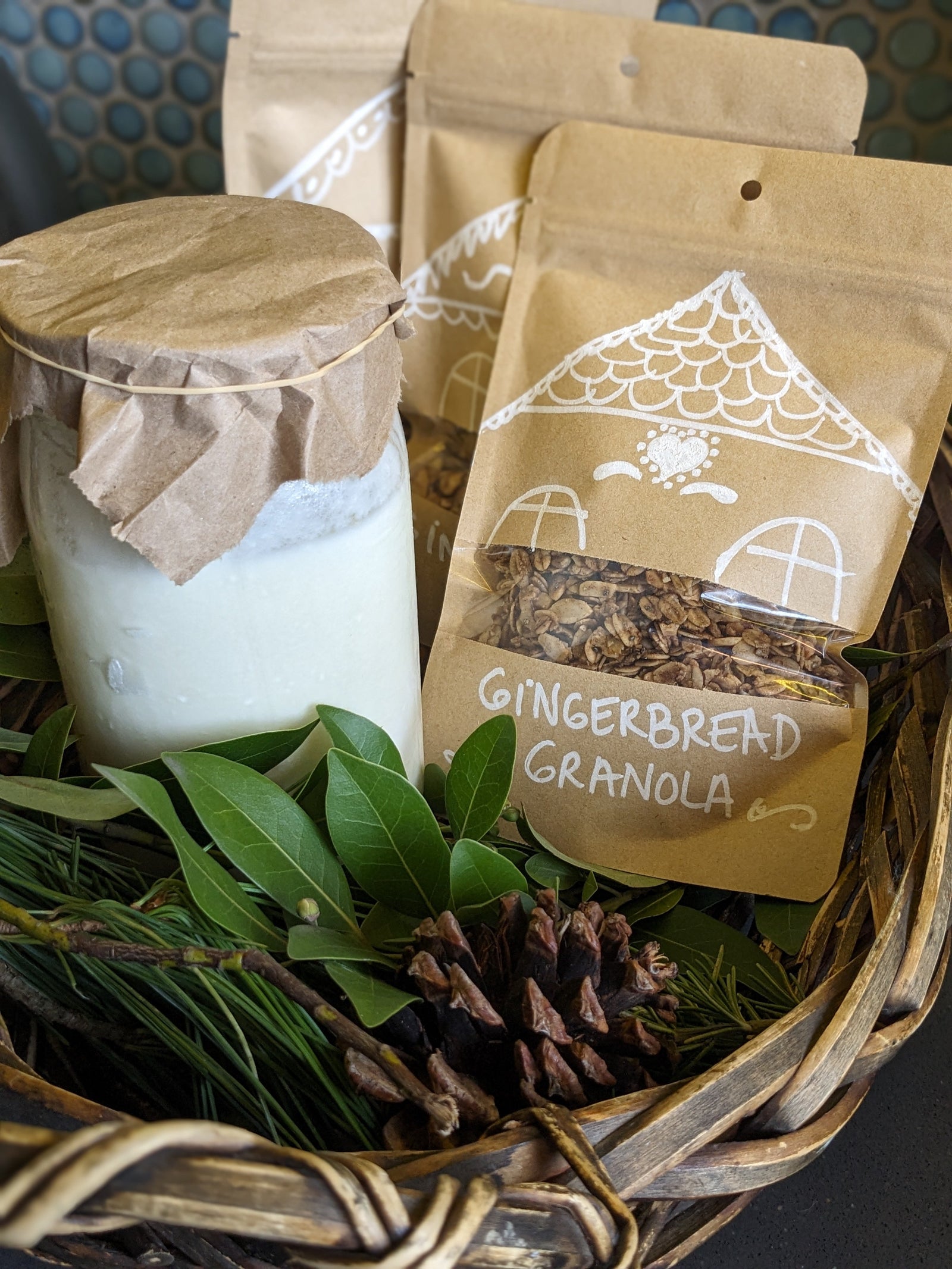 basket of homemade yogurt in a jar and some bags of homemade gingerbread granola