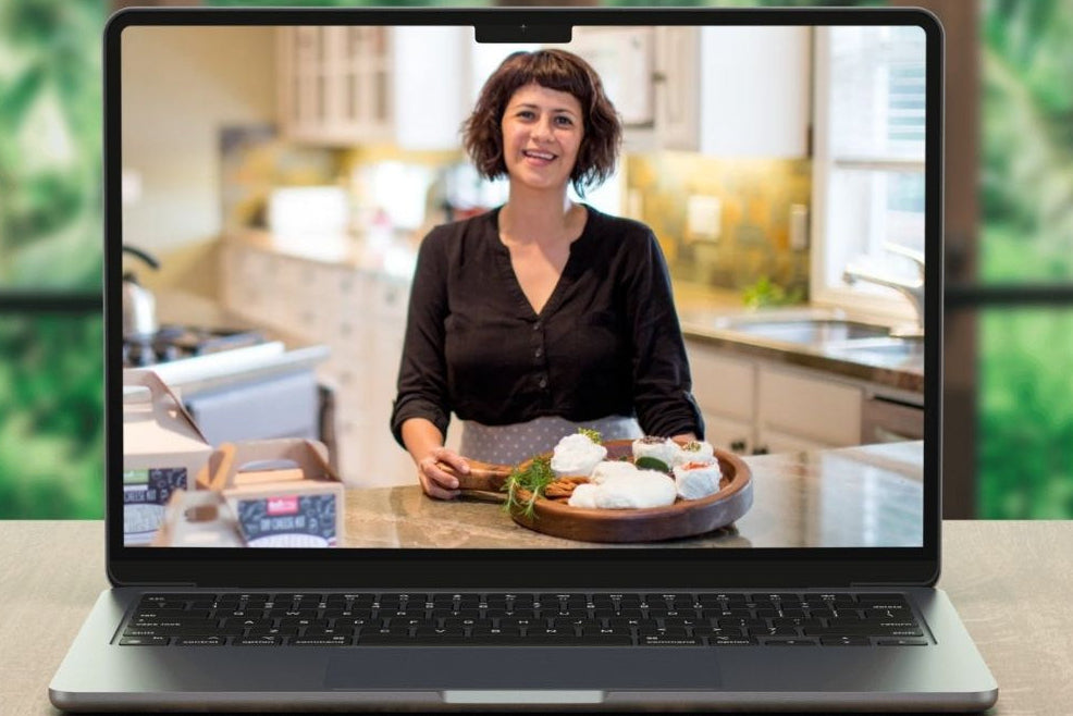 A cheesemaking instructor on a laptop