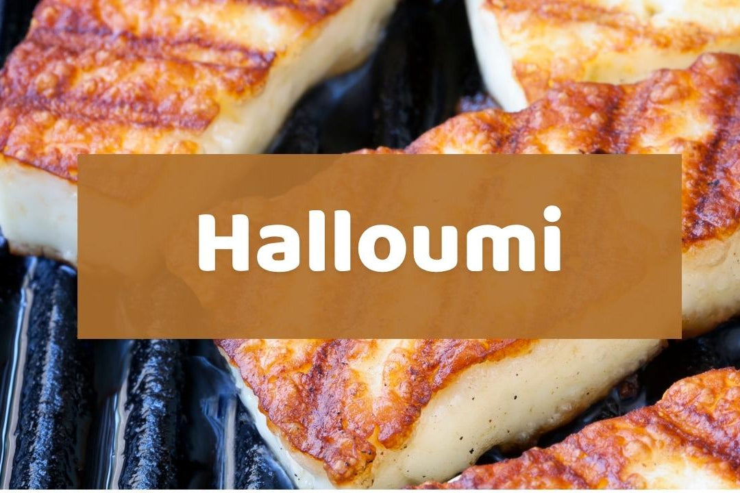 Grilled halloumi cheese slices with golden-brown charred marks on a dark grill, overlaid with a semi-transparent brown banner containing the white text 'Halloumi'.