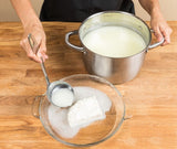 whey being ladled onto curd