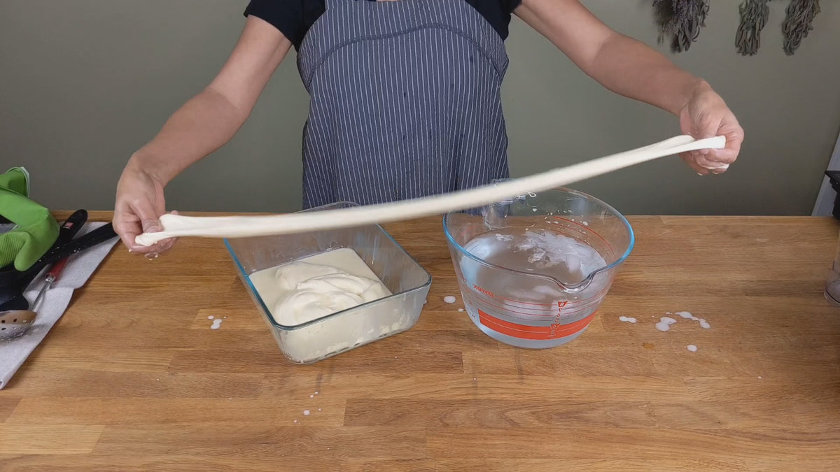 cheesemaker stretching string cheese